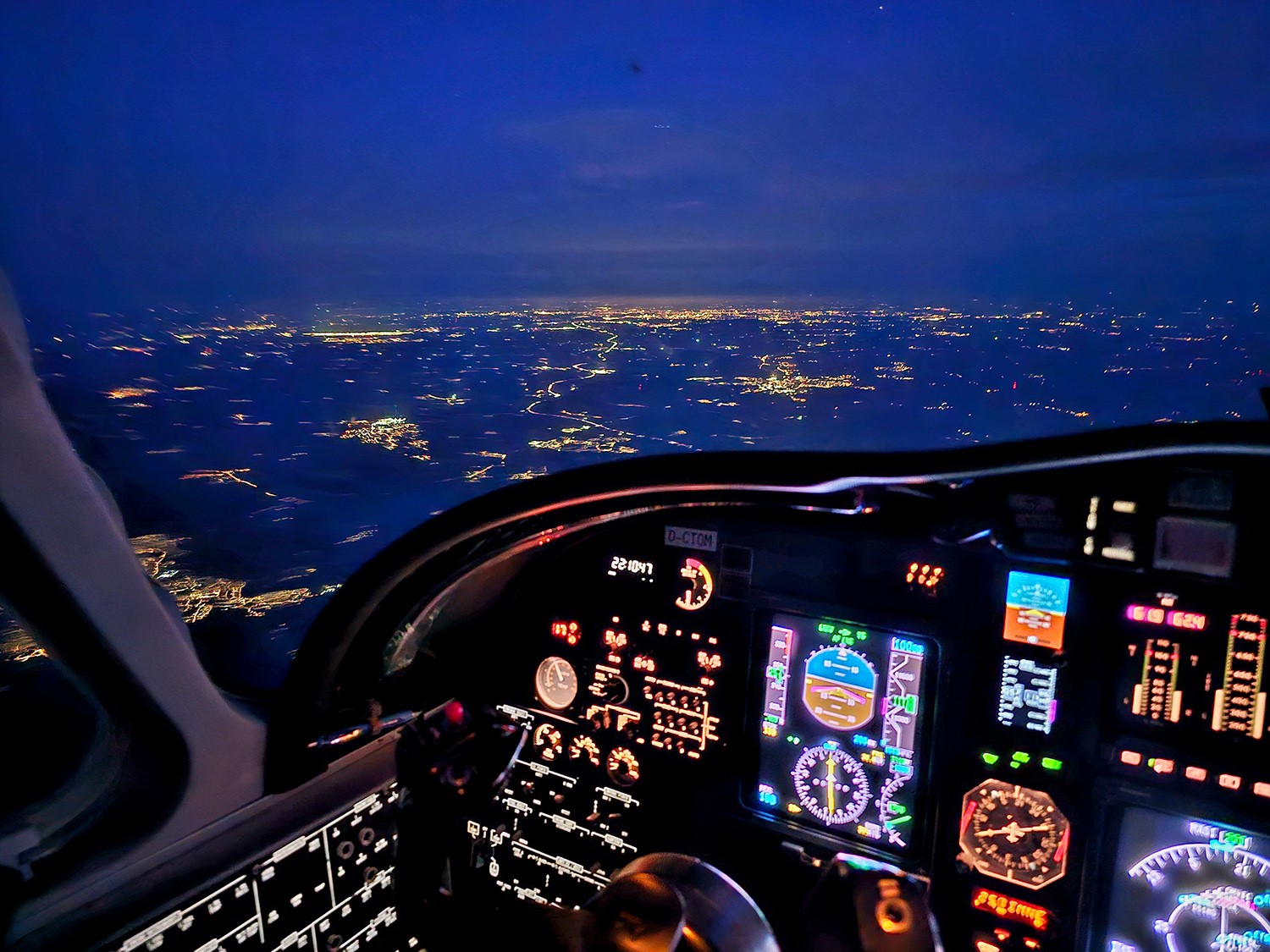 Nachtflug über eine Stadt im Helikopter